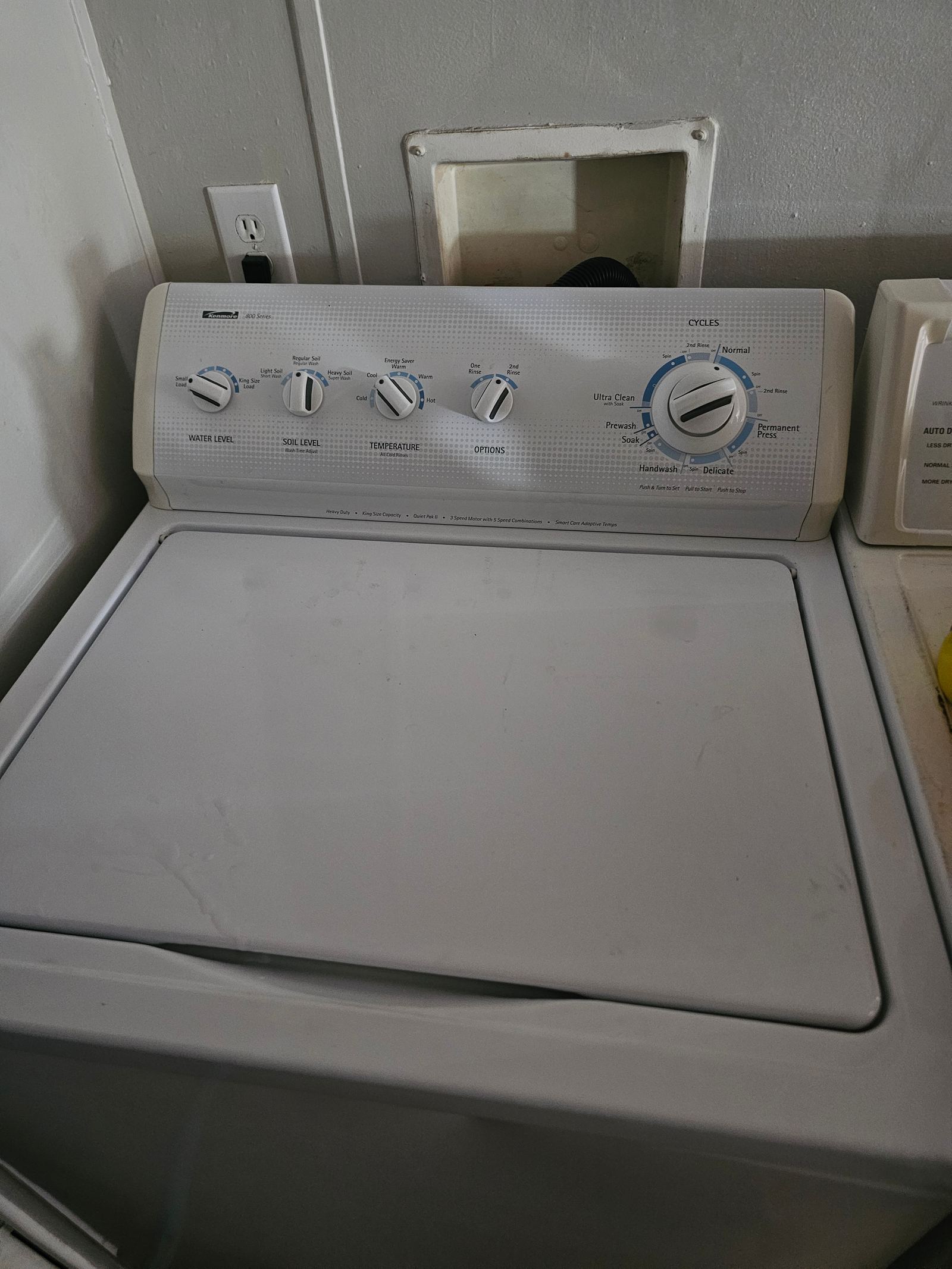 Close-up of a washer set up and hooked up in a customer's laundry closet